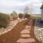 side yard landscape design with stones and pebbles