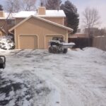 Snow plow outside of home removing snow