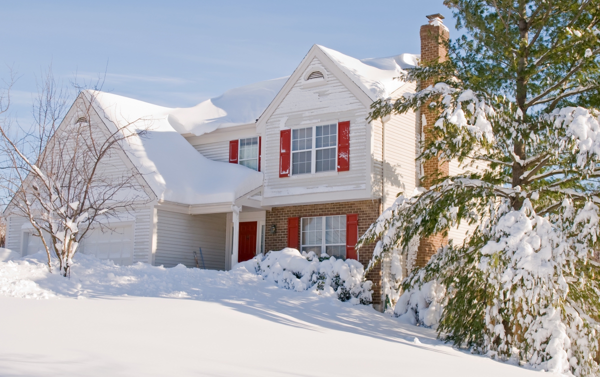suburban house covered in heavy snow